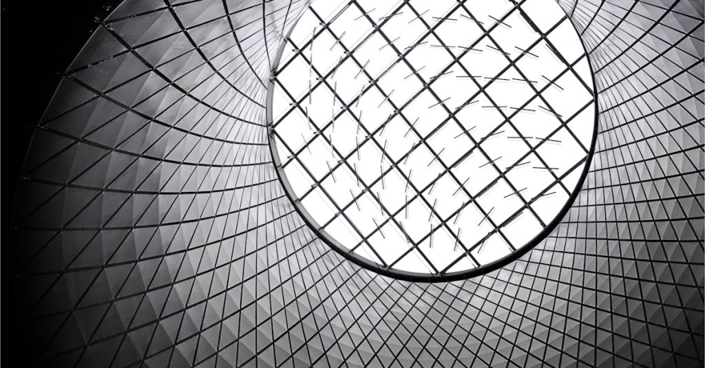Worm's eye view of a futuristic geometric skylight showcasing modern architecture.